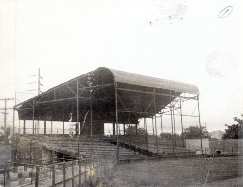A set of covered bleachers on a sports field.
