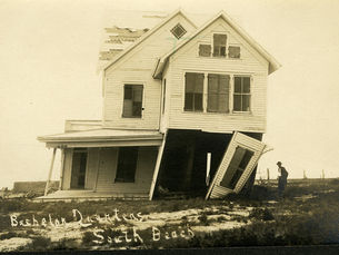 A damaged house listing to one side. Writing on photo reads Bachelor Quarters South Beach