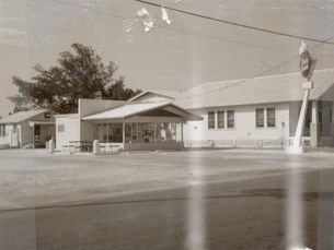 a storefront with a sign at the corner of the lot that reads dairy queen