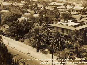 Aerial view of a street and buildings. Writing on photo reads Key West viewed from the lighthouse, home of Ernest Hemingway in foreground. 161.