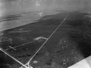 aerial view of a mostly undeveloped island with roads through it