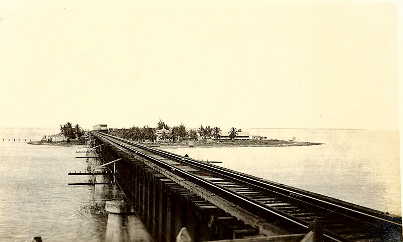A railroad bridge leading to a small island.