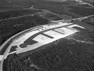 Aerial view of a dredged and scarified area, surrounded by mangroves