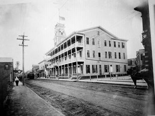 A three-story building with porches on each level and a cupola at the center