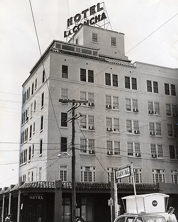 A six-story building with a sign on top that says Hotel La Concha.