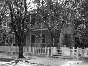 A two-story building with porches on both levels