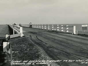 A bridge with people standing on the side fishing. Text on photo reads Scene on Overseas Highway to Key West, Fla. Channel No. 5 viaduct. No. 492