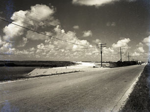 A road with a dirt bypass on the left side.