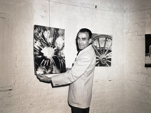 A man with a photo hanging on the wall