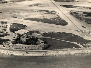 Aerial view of a shoreline with a fort and runways