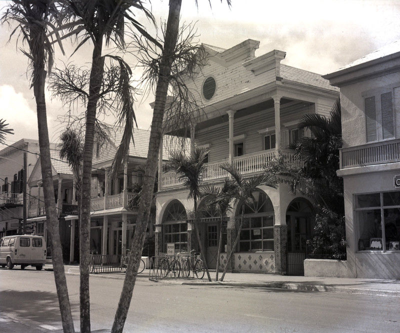 A street with two story buildings of wood frame and masonry.