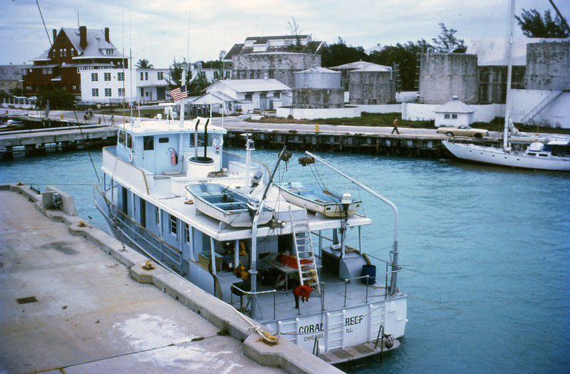 A boat with Coral Reef written on the stern at a dock