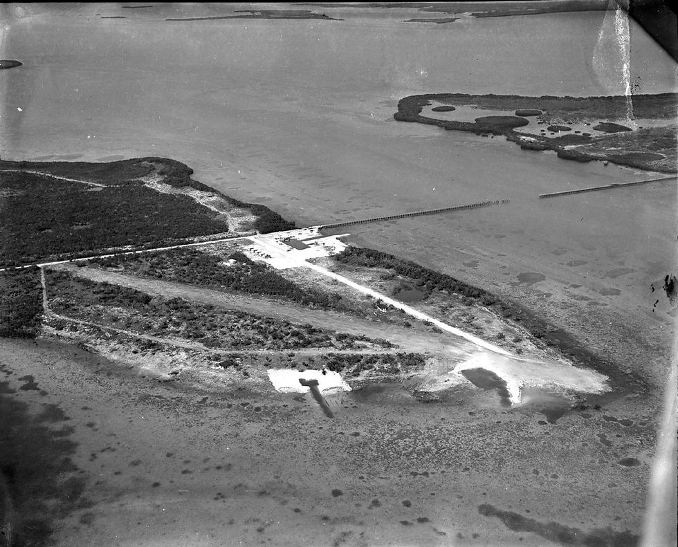 Aerial view of an island with a road and some development.