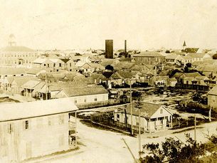 aerial view of a town with streets and one and two-story buildings