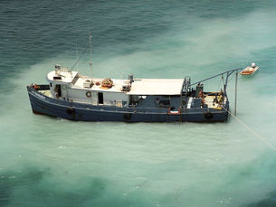 Aerial view of a ship on the water with JB Magruder written on the hull