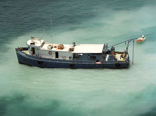 Aerial view of a ship on the water with JB Magruder written on the hull