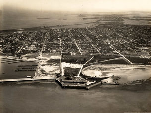 Aerial view of a developed island with a waterfront fort in the foregound.