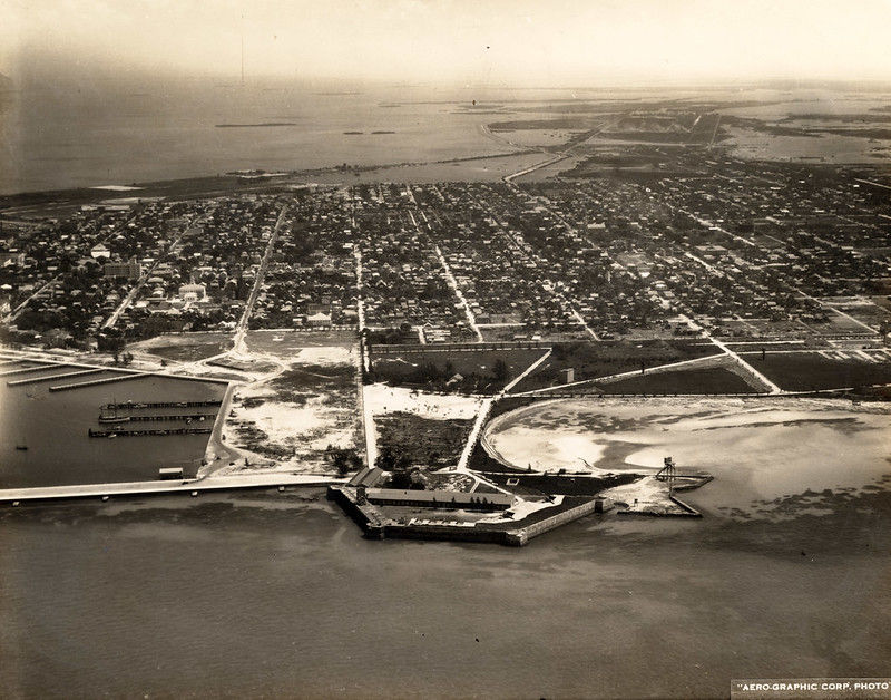 Aerial view of a developed island with a waterfront fort in the foreground.