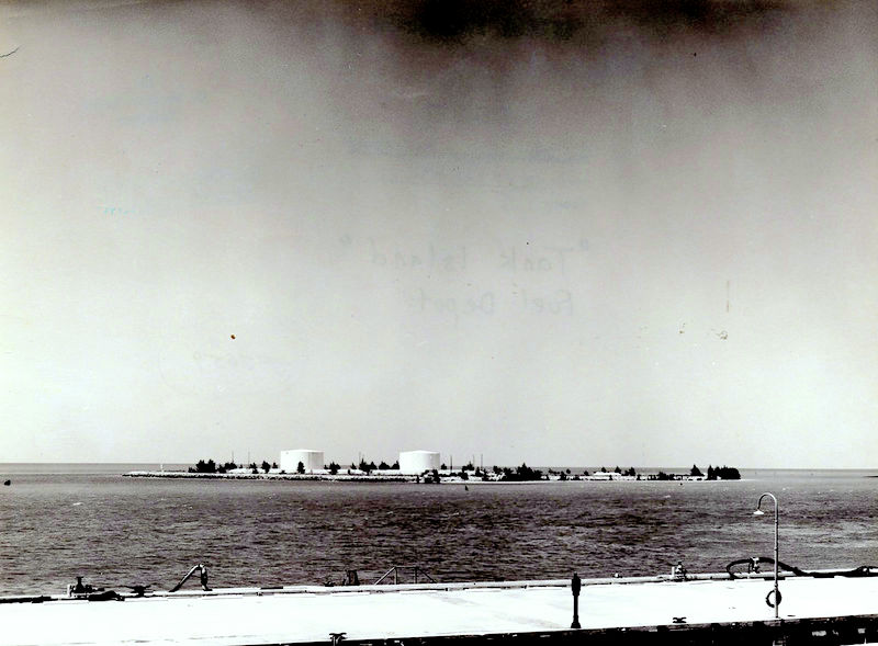 An island with two large tanks on it.