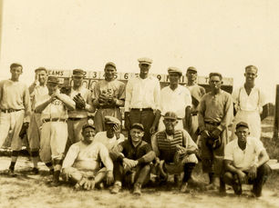 Two rows of people, some in baseball uniforms.