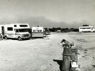 campers near an overflowing trash can