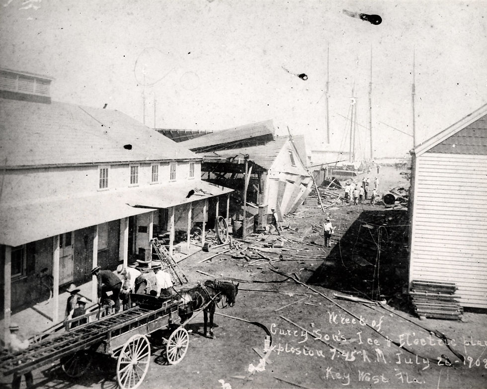 People along with a horse and cart standing behind a ruined building. Handwriting on image reads wreck of Curry Sons Ice and electric plant explosion 7:45 AM July 26 1909 Key West Fla.