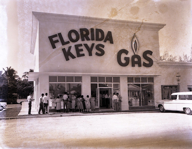 People in front of a building with Florida Keys Gas written on the facade.