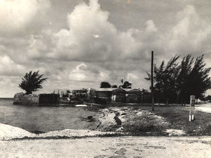 A beach leading to a brick fort structure