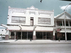 A two-story building with storefronts downstairs and the name Page in the facade.