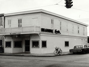 A building on a street corner with signs on the front and side reading Wm. Gamble Jeweler