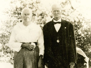 An older woman and man stand outside
