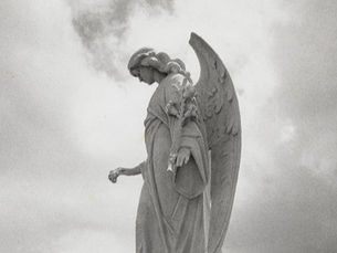 A statue of an angel looking down.