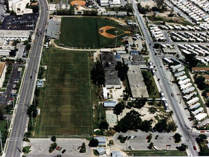 aerial view of sports fields with buildings around them