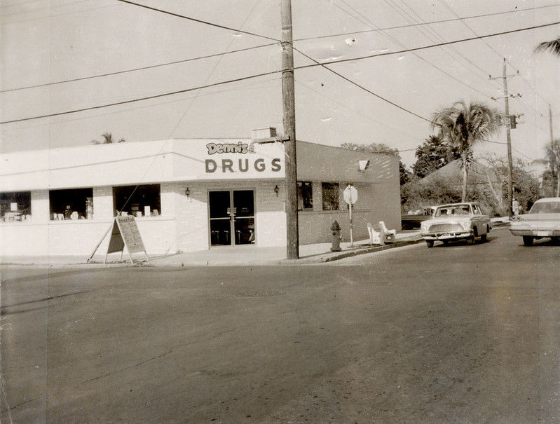 A building with a sign that reads Dennis drugs