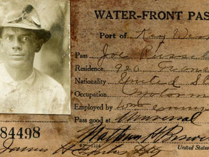 A card titled water-front pass with a photo and identifying information for Joe Russell