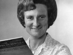 A woman holds a copy of American Heritage magazine