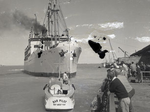 a ship near a dock with a smaller boat labeled Bar Pilot Key West FLA in front of it.