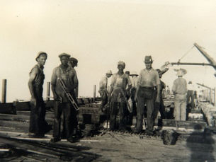 A group of men standing on a bridge under construction