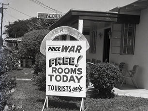A sign that reads Price War. Free! Rooms today. Tourists only.
