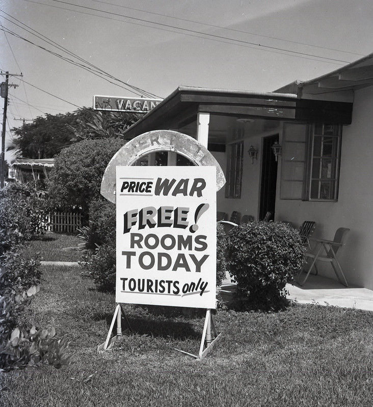 A sign that reads Price War. Free! Rooms Today. Tourists only.
