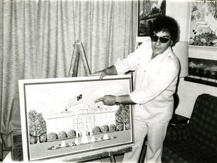A man pointing at a wood carving of the White House