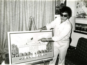 A man pointing at a wood carving of the White House