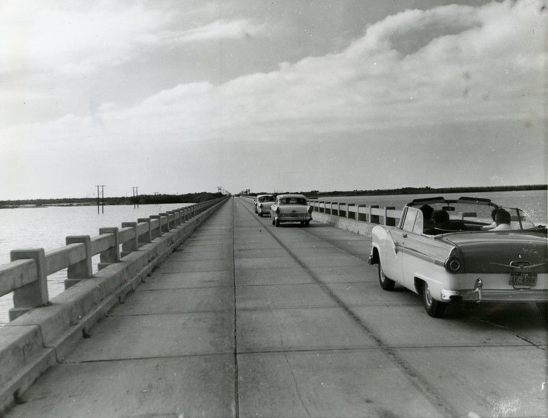 1950s style cars crossing a bridge