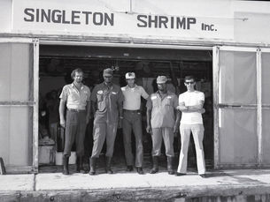 Five men standing in front of a warehouse labeled Singleton Shrimp In.c