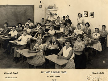A class of students sitting at desks. Text reads May Sands Elementary School, Key West, Florida, 1956-57.