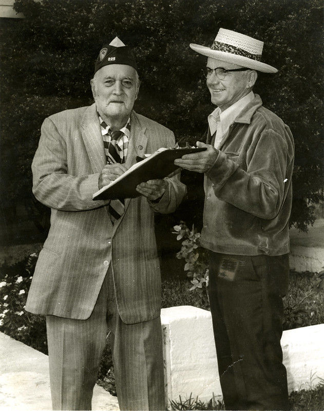 Two men with a clipboard
