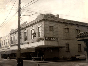 A large storefront on a corner with an awning and a sign that reads Kress