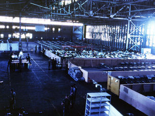 A large area divided up with rows of cots