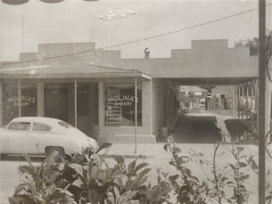 A storefront with Molina's Bakery written on the windows