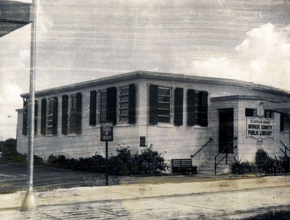 A building with dark shutters and a sign that reads Islamorada Branch Monroe county Public Library.